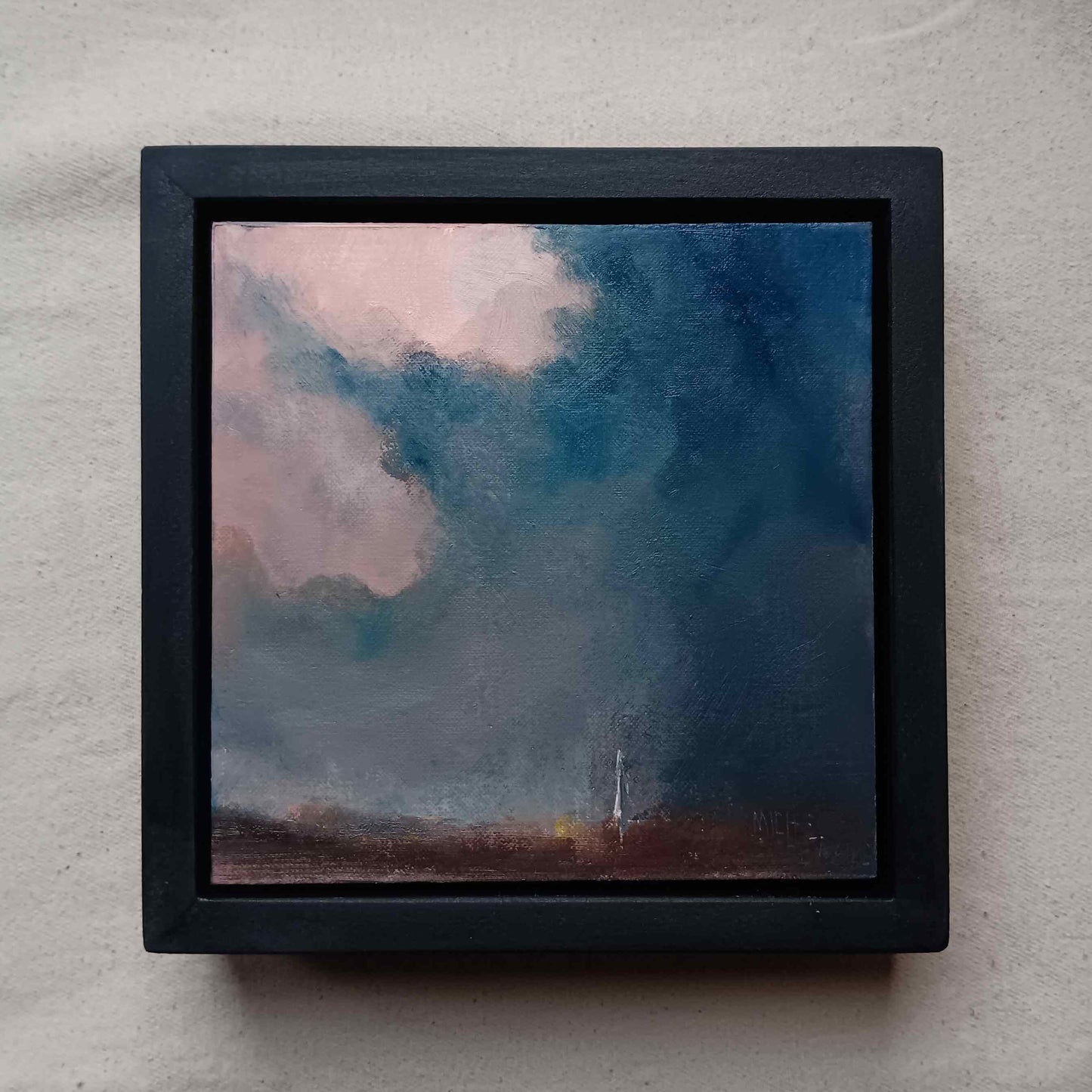framed oil painting of a dramatic sky over salisbury with cathedral in distance
