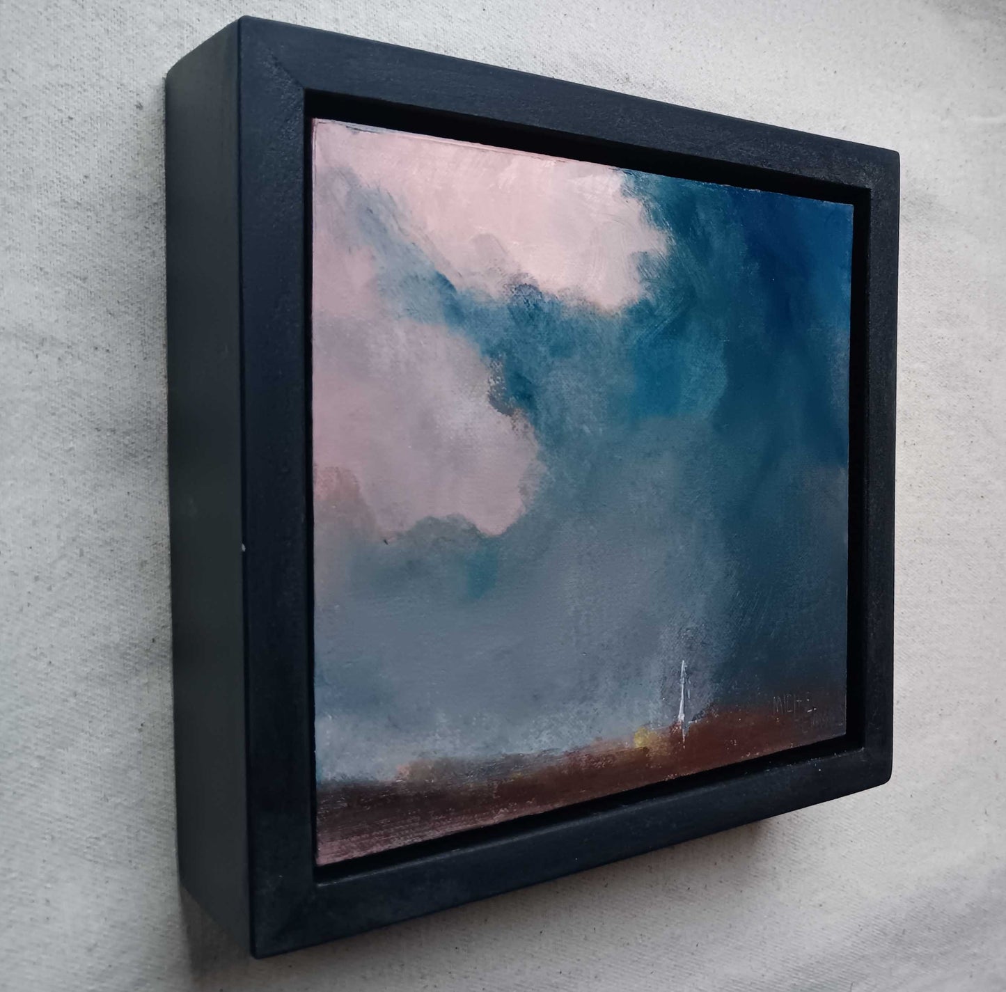 framed oil painting of a dramatic sky over salisbury with cathedral in distance