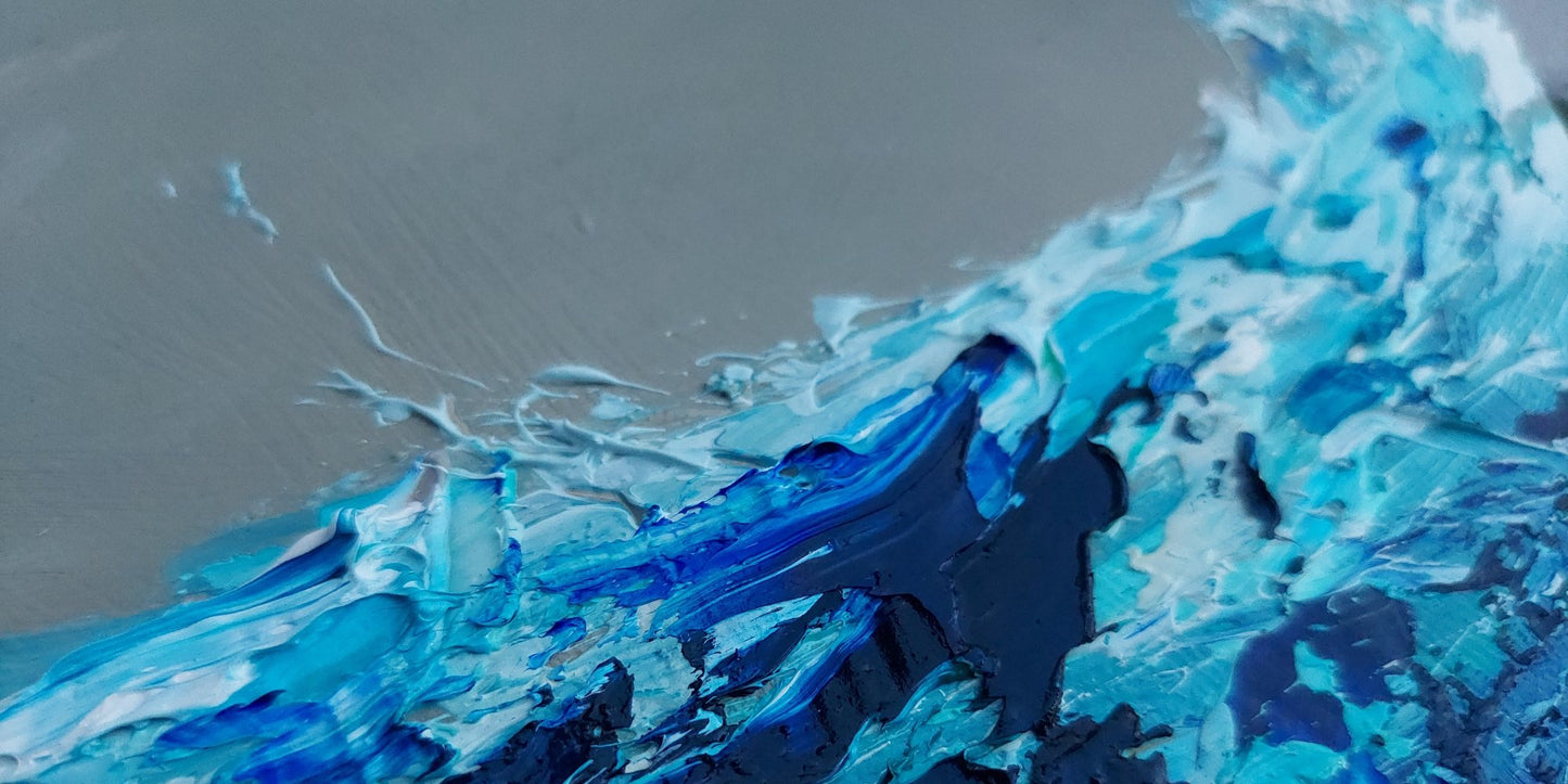 Close-up of blue and white abstract art on a textured surface