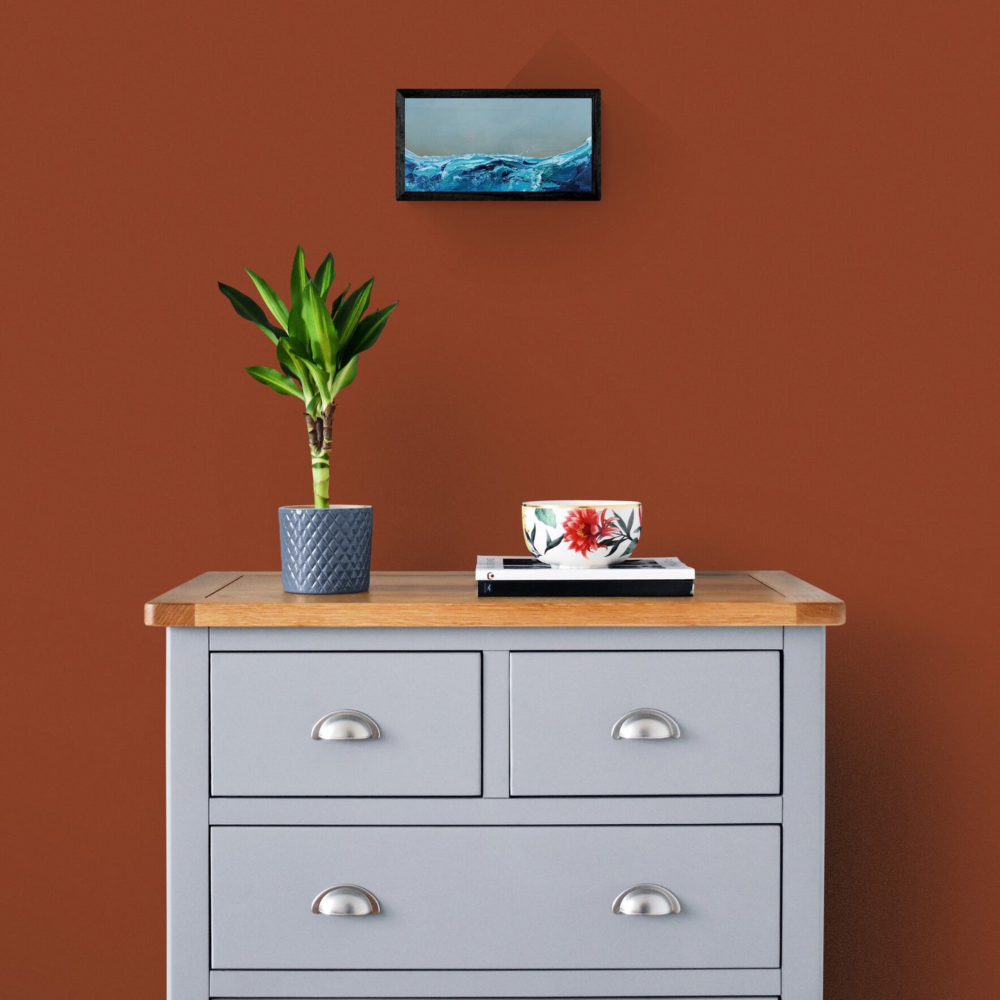 Framed seascape painting in room setting