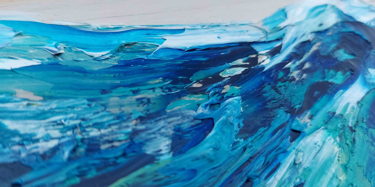Close up of painting of blue and white waves on a light gray background