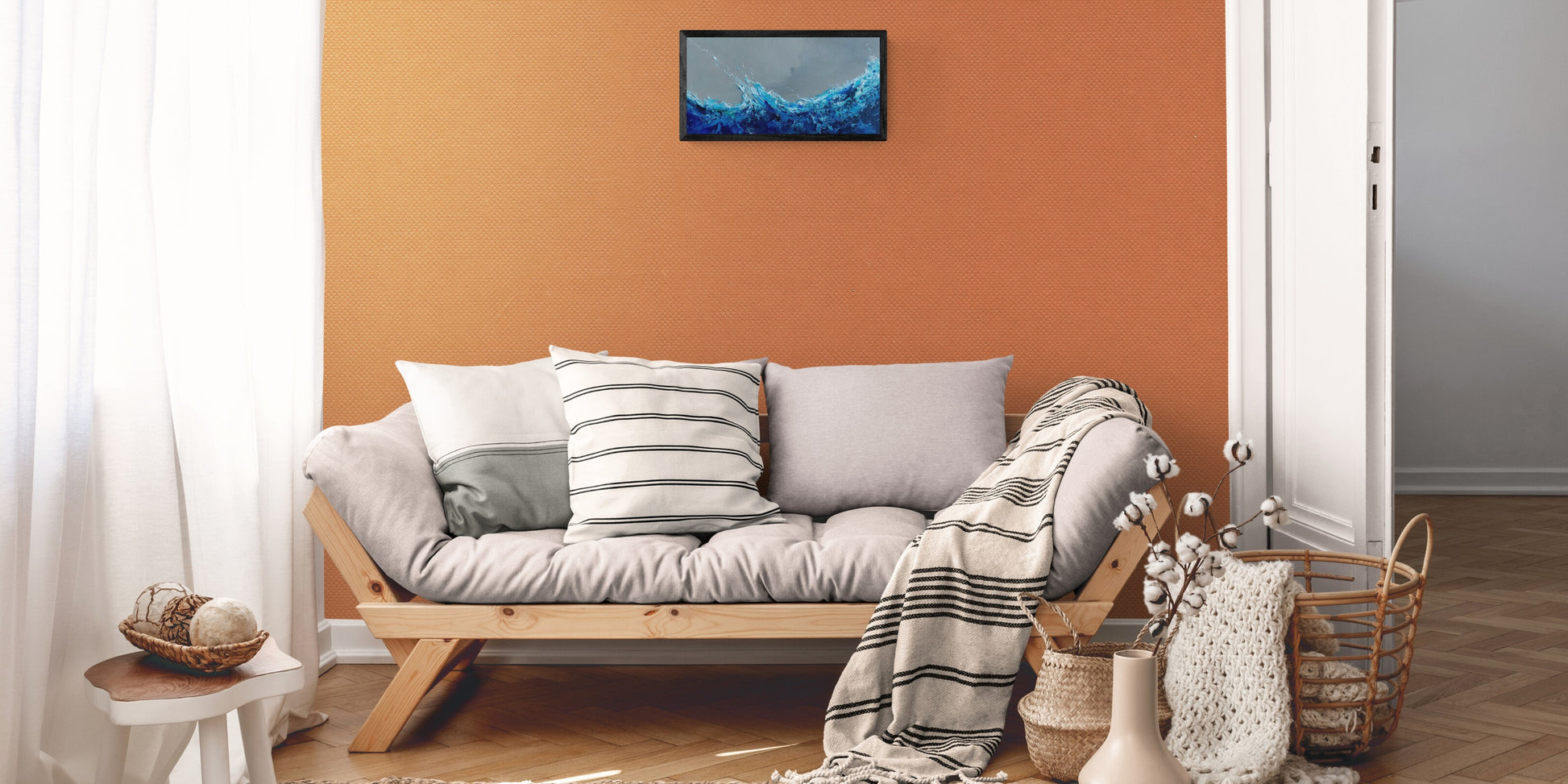 Cozy living room with a wooden sofa against an orange wall, featuring a painting.