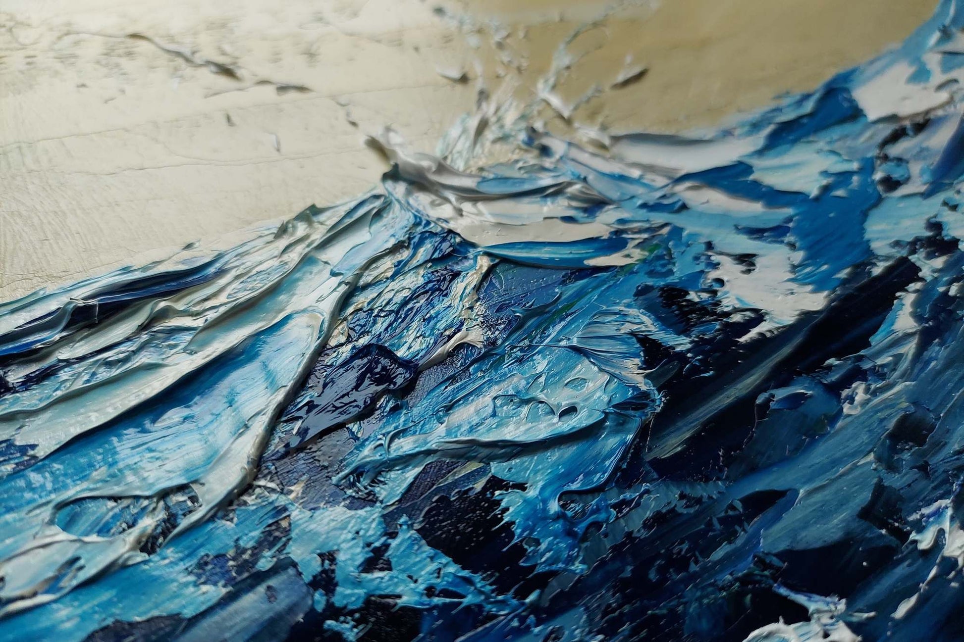Close-up of a textured surface with blue and black paint strokes