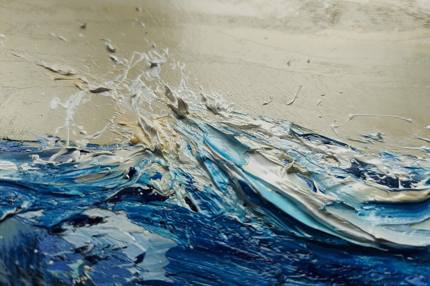 Abstract painting of blue and white waves on a sandy background